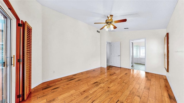 unfurnished bedroom with connected bathroom, light hardwood / wood-style flooring, ceiling fan, and vaulted ceiling