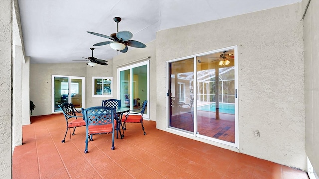 sunroom featuring a patio area and ceiling fan