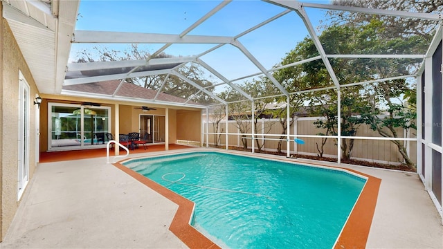 view of swimming pool featuring a patio, a lanai, and ceiling fan