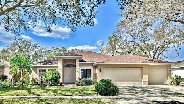 view of front of home with a garage and a front yard