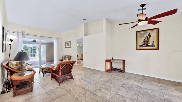 sitting room featuring lofted ceiling, light tile patterned floors, and ceiling fan