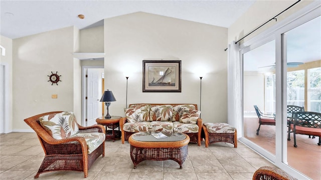 living room with lofted ceiling and light tile patterned floors