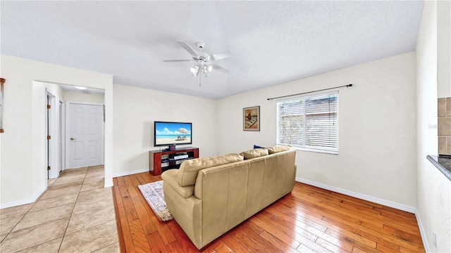 living room featuring ceiling fan and light wood-type flooring