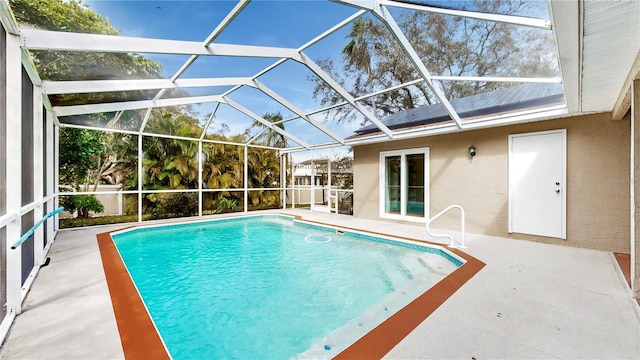 view of swimming pool with a patio area and glass enclosure