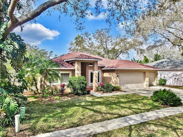 mediterranean / spanish-style house with a garage and a front yard