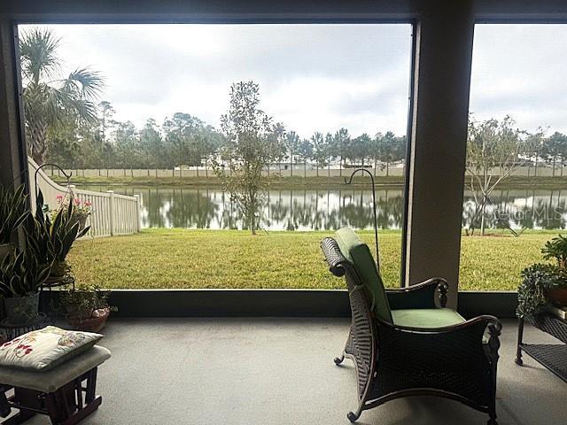 sunroom featuring a water view and plenty of natural light