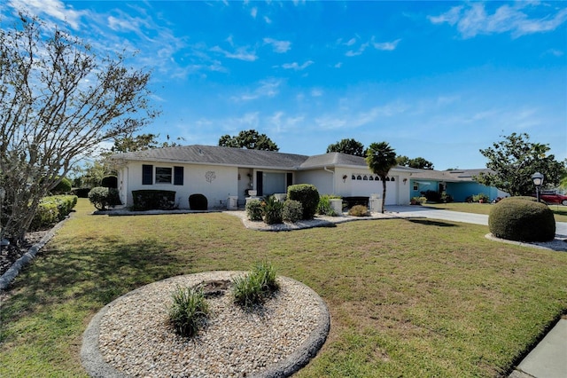 ranch-style home featuring a garage, concrete driveway, and a front yard