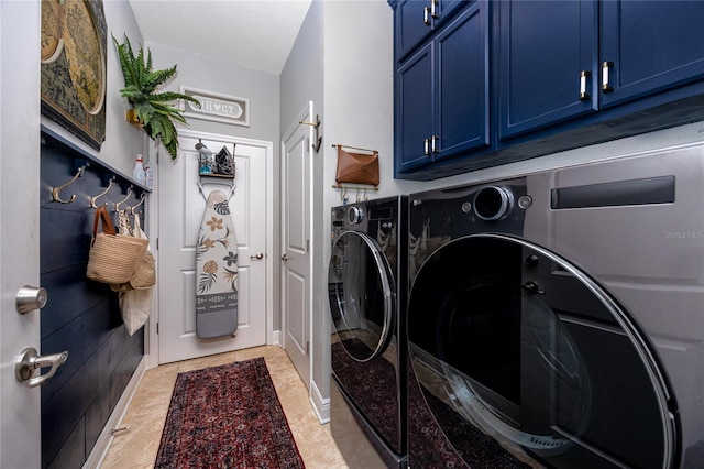 washroom featuring cabinets and independent washer and dryer