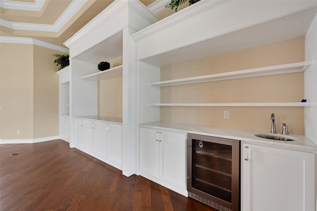 bar with sink, crown molding, dark wood-type flooring, white cabinetry, and wine cooler