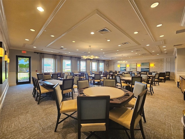 dining space with ornamental molding, light carpet, and an inviting chandelier