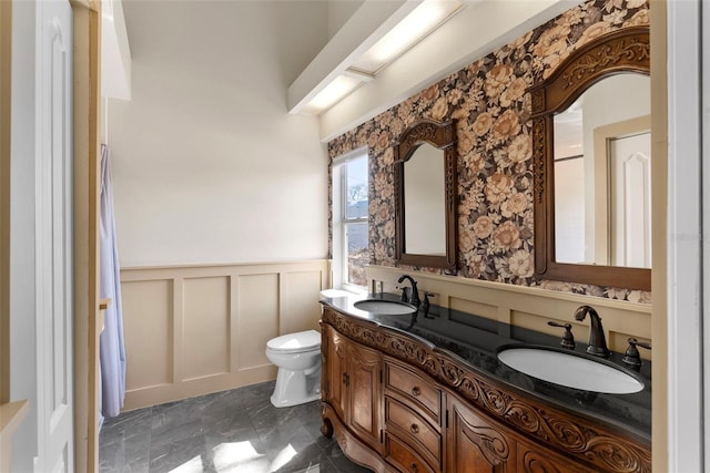 bathroom featuring vanity and toilet