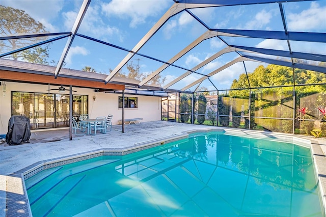 view of pool featuring a lanai, a patio, and ceiling fan