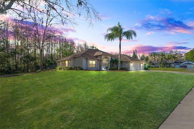 ranch-style house with an attached garage, fence, a front lawn, and concrete driveway