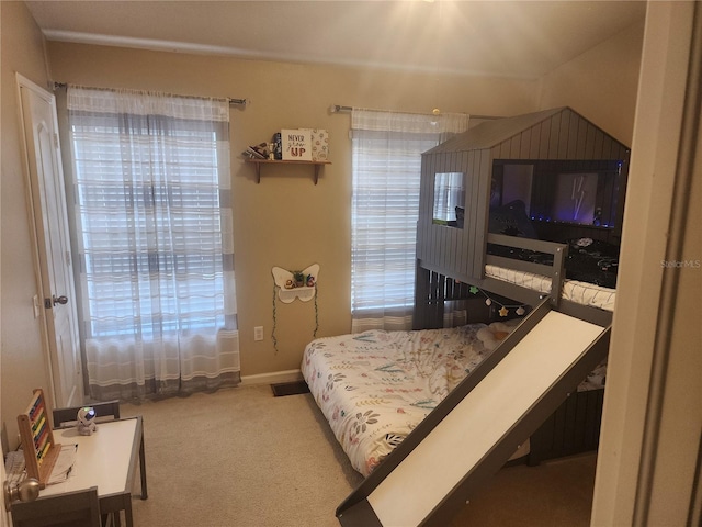 carpeted bedroom featuring baseboards