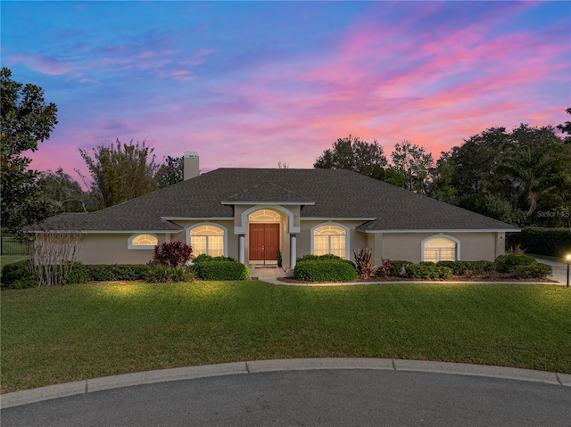 ranch-style home featuring a yard