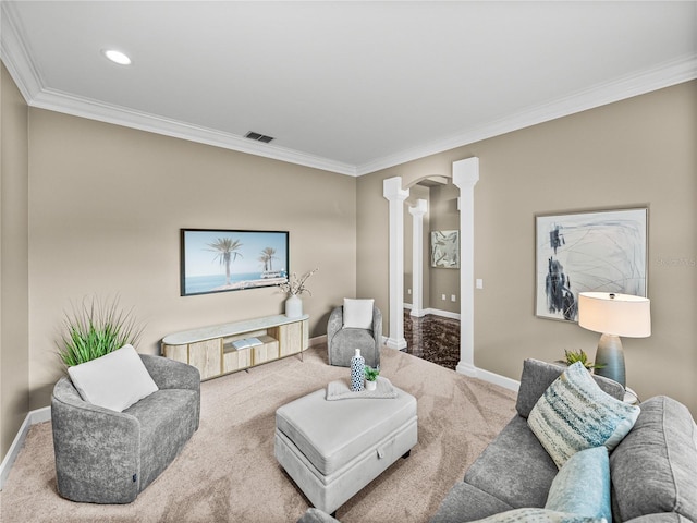 living room with decorative columns, ornamental molding, and carpet floors