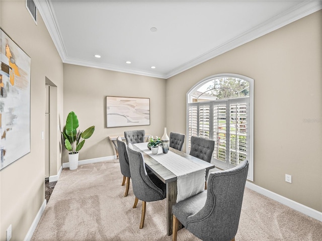 dining area featuring light colored carpet and ornamental molding