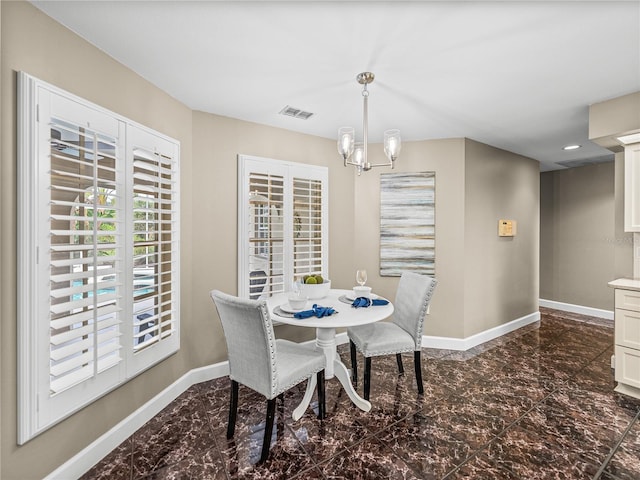 dining space featuring a notable chandelier