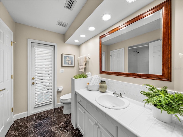 bathroom with vanity, toilet, and walk in shower