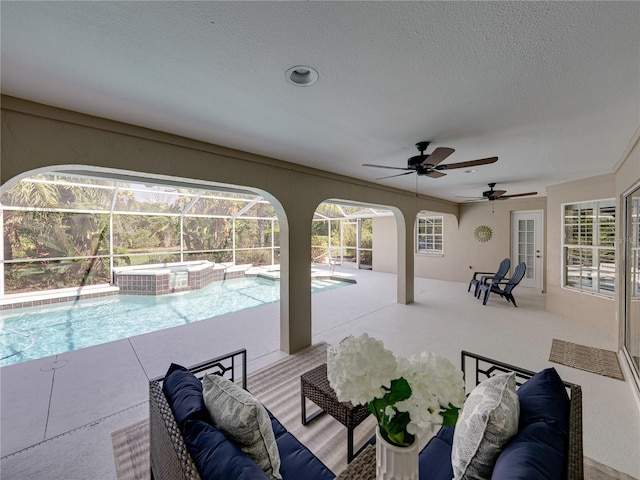 view of swimming pool with an in ground hot tub, outdoor lounge area, glass enclosure, and a patio