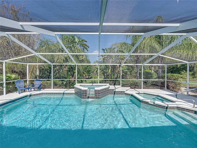 view of pool with an in ground hot tub, a lanai, and a patio area