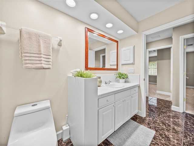 bathroom with vanity and toilet