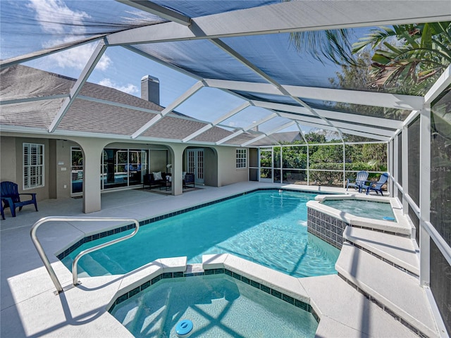 view of swimming pool featuring an in ground hot tub, a lanai, and a patio area