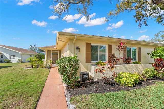 ranch-style home with a front lawn and stucco siding