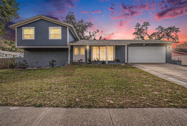 view of front of home featuring a garage and a lawn