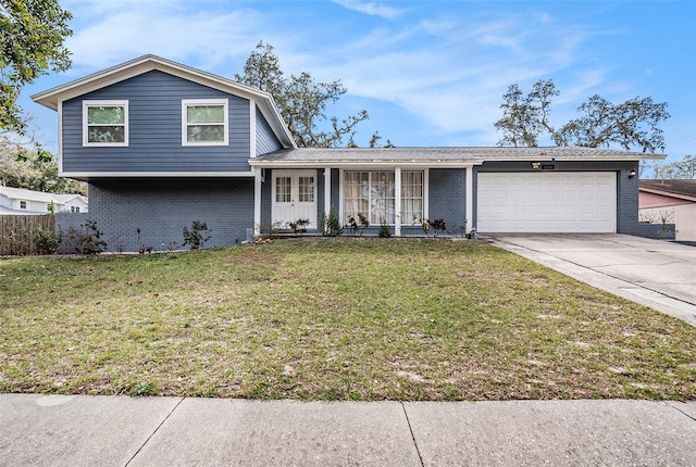 view of front of house featuring a garage, a front yard, and a porch