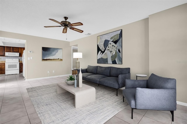 tiled living room with ceiling fan