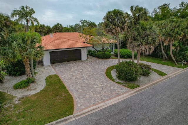 mediterranean / spanish house featuring a garage