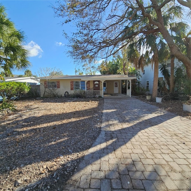 single story home featuring a carport