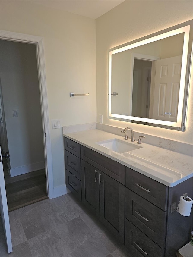 bathroom with vanity and baseboards