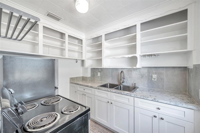 kitchen with white cabinetry, light stone countertops, sink, and electric range