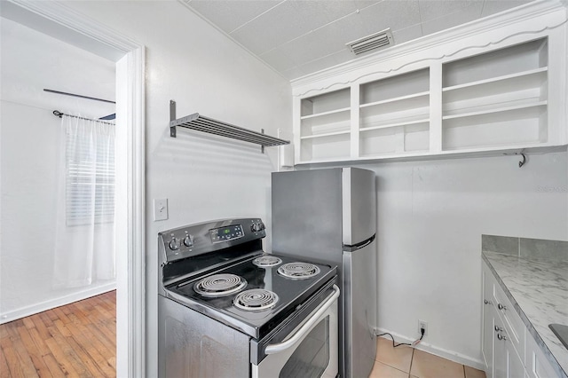 kitchen featuring appliances with stainless steel finishes, ventilation hood, white cabinets, light stone countertops, and light wood-type flooring