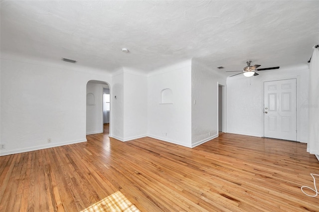 unfurnished living room with ceiling fan, light hardwood / wood-style flooring, and a textured ceiling