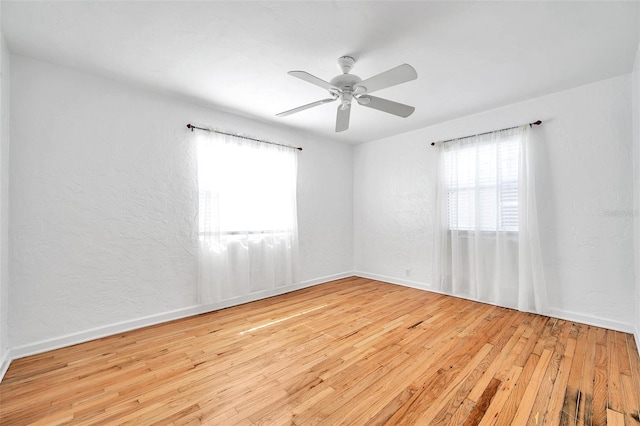 spare room featuring light hardwood / wood-style flooring and ceiling fan