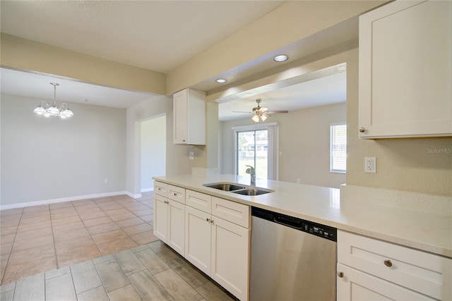 kitchen featuring light countertops, a sink, stainless steel dishwasher, and white cabinetry