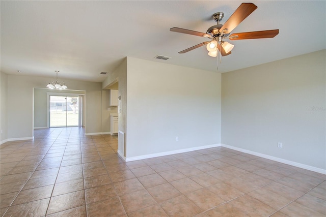 unfurnished room featuring light tile patterned flooring, visible vents, baseboards, and ceiling fan with notable chandelier