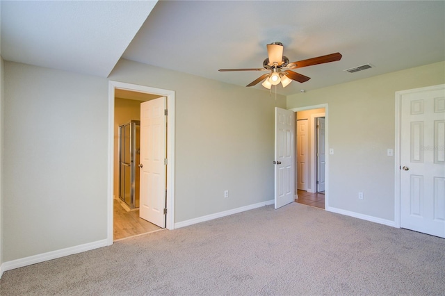 unfurnished bedroom featuring baseboards, visible vents, connected bathroom, and carpet flooring