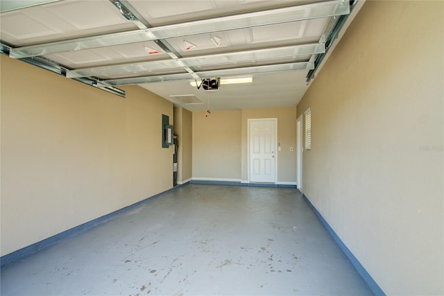 garage featuring electric panel and baseboards