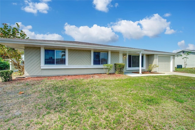 ranch-style house featuring a garage, driveway, and a front lawn