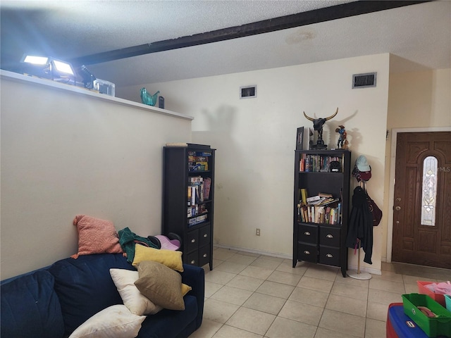 bedroom featuring light tile patterned floors, a textured ceiling, and visible vents