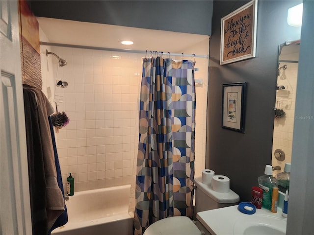 bathroom featuring toilet, shower / bath combination with curtain, and vanity