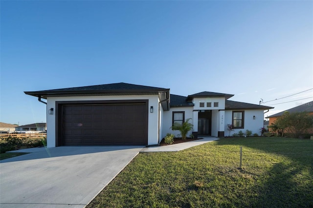 view of front of home with a garage and a front yard