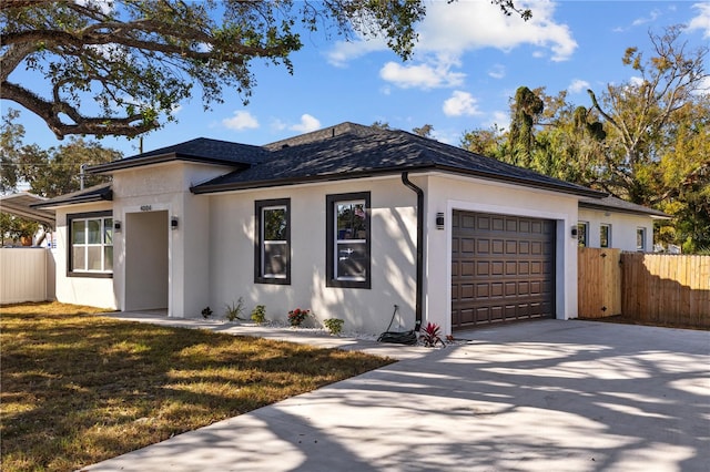 view of front of house featuring a front lawn and a garage