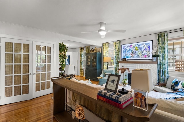 office space featuring wood-type flooring, french doors, and ceiling fan