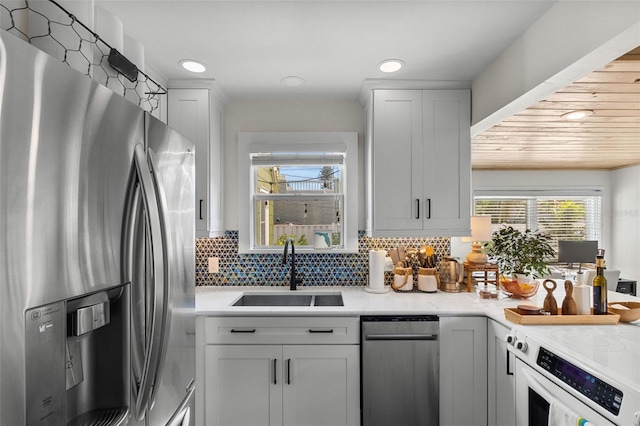 kitchen featuring stainless steel refrigerator with ice dispenser, sink, and white cabinets