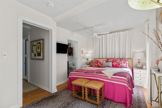 bedroom featuring connected bathroom, hardwood / wood-style flooring, and ceiling fan